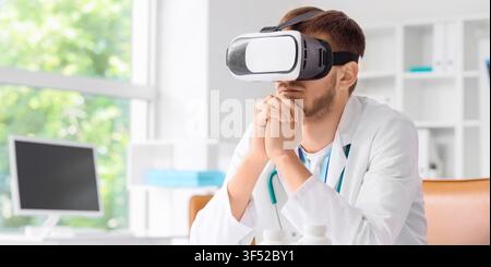 Male doctor wearing virtual reality headset in a modern medical office, healthcare technology and innovation Stock Photo