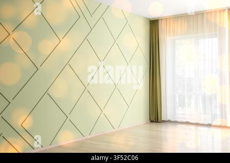 Empty room interior with light green wall paneling, wooden floor, and window with sheer and olive green curtains Stock Photo