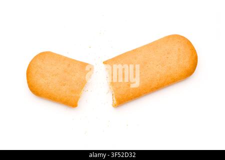 Broken golden rectangular cracker with scattered crumbs on white background Stock Photo