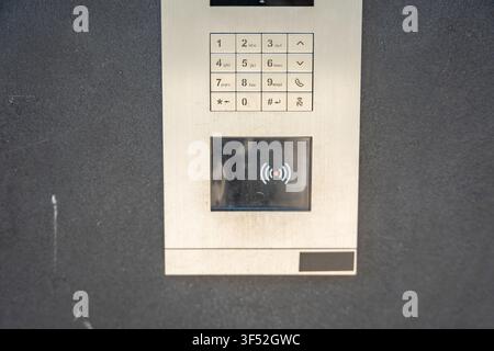 Modern apartment building intercom with keypad and contactless access system. Secure residential access highlights smart building technology and Stock Photo