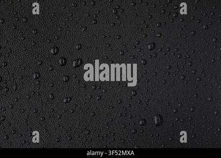 Macro leather texture with water drops, waterproof and hydrophobic surface concept, warm black background Stock Photo