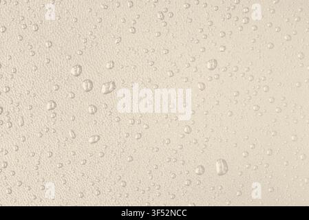 Macro leather texture with water drops, waterproof and hydrophobic surface concept, classical warm beige background Stock Photo