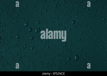 Macro leather texture with water drops, waterproof and hydrophobic surface concept, teal background Stock Photo