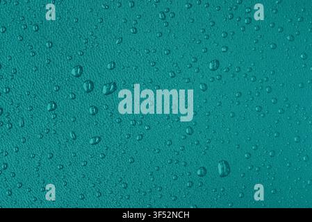 Macro leather texture with water drops, waterproof and hydrophobic surface concept, teal background Stock Photo