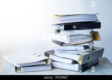 Stack of used file folders containing clear plastic sleeves and documents, business concept for bookkeeping, accounting, office work, and bureaucracy, Stock Photo