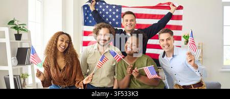 Diverse friends celebrating USA Independence Day at home with American flags. Stock Photo