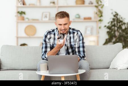 Young man using voice assistant on his smart phone Stock Photo