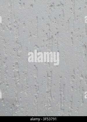 Close-up of a white textured plaster wall with rough stucco finish. Abstract construction background featuring decorative wall texture, ideal for architecture, renovation, interior design, and graphic design projects. Stock Photo