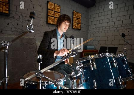 Lively young white percussionist engaged in practice with instruments Stock Photo