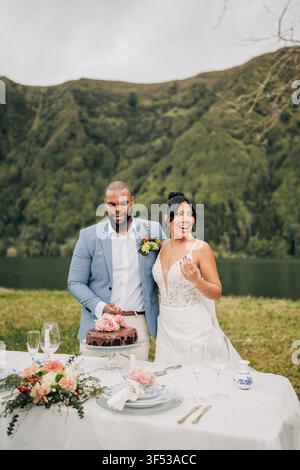 Happy couple celebrating their elopement outdoors Stock Photo