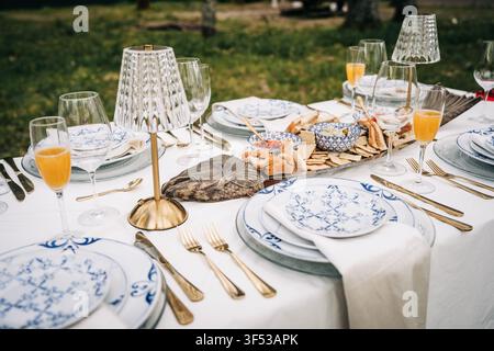 Stylish alfresco dining table with appetizers and mimosas Stock Photo
