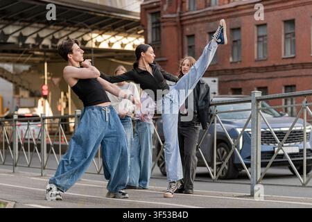 Flexible woman high kicking during a street dance Stock Photo