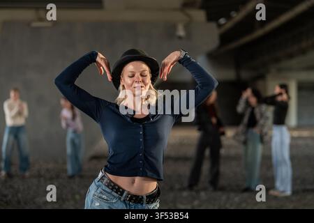 Expressive young woman dancing in a hat Stock Photo