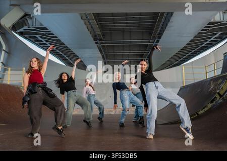 Young female dance crew striking a pose under a bridge Stock Photo