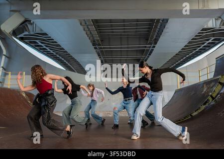 Young dancers rehearsing in an urban skatepark Stock Photo