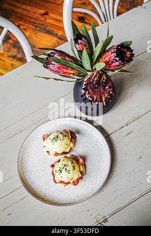 Delicious eggs Benedict brunch on a rustic white table Stock Photo