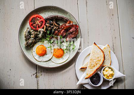 Big hearty breakfast plate on a rustic table Stock Photo