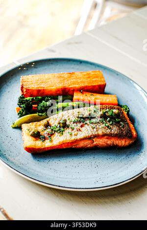 Pan seared salmon fillet with potatoes and vegetables Stock Photo