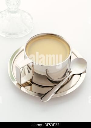 Modern silver coffee cup and saucer on white Stock Photo