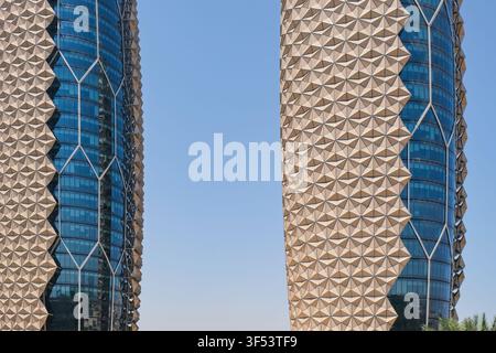 Abstract geometric mashrabiya facade, triangular shading elements of Al Bahr Towers. Sustainable climate responsive architecture. Stock Photo