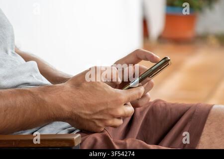 Hands holding smartphone, interacting with technology. Connectivity and communication in a digital world Stock Photo