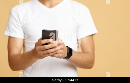 Social networks, blogs and mobile app. Smiling student watch in glasses hold modern phone Stock Photo