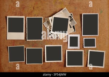 old empty photo frames, vintage blank photographic prints on wood with free space for pictures Stock Photo