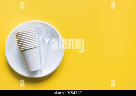 Picnic utensils for recycling on yellow. Environment eco friendly discarded plastic garbage collection for recycle concept.Top view. Flat lay. Stock Photo
