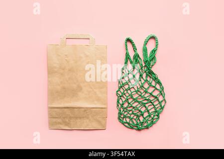 Empty shopping paper and textile bag on pink. Zero waste. Stock Photo