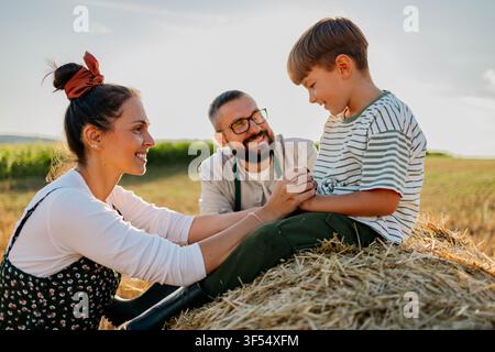 Farmer family taking a selfie in a wheat field Stock Photo
