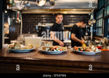 Restaurant chefs preparing food in a professional kitchen Stock Photo