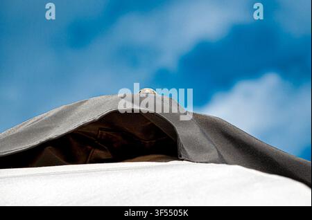 large beach umbrellas against a cloudy blue sky Stock Photo
