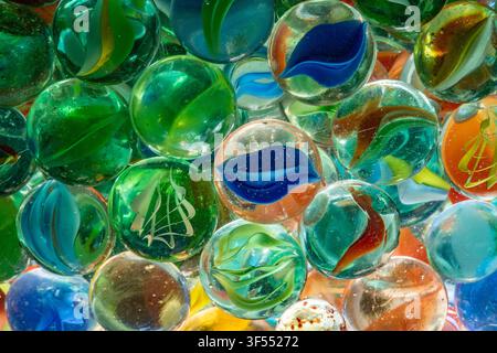 Glass marbles filling the frame, showing colorful patterns and vivid reflections Stock Photo