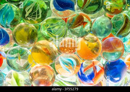 Glass marbles in various colors and designs forming a tight, bright background Stock Photo