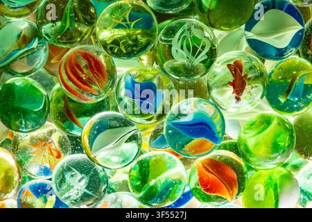 Marbles displaying vibrant colors and intricate designs, creating an optical illusion Stock Photo