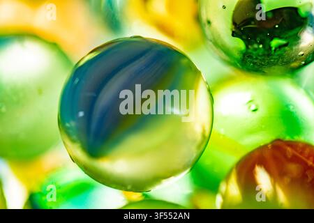 Macro view showing colorful swirling glass marble with reflections Stock Photo