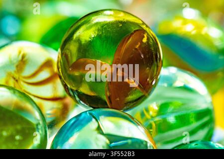 Glass marbles in various colors creating a vibrant background texture Stock Photo