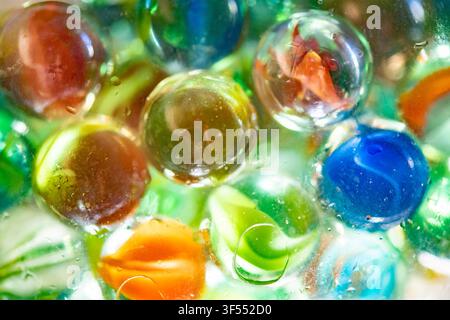 Glass marbles in various colors and patterns creating an abstract, nostalgic design Stock Photo