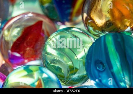 Abstract background showing translucent glass marbles with vibrant colors and bokeh Stock Photo