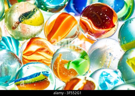 Glass marbles in various colors and patterns creating a vibrant background Stock Photo