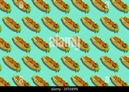 Healthy fast food and delivery for party. Hot dogs with sausages, salad and vegetables on turquoise background Stock Photo
