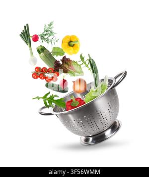 Fresh vegetables and colander in air on white background Stock Photo