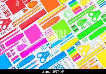 Colorful school and office stationery arranged in a flat lay composition on a white background. Ideal for education, back to school, office supplies a Stock Photo