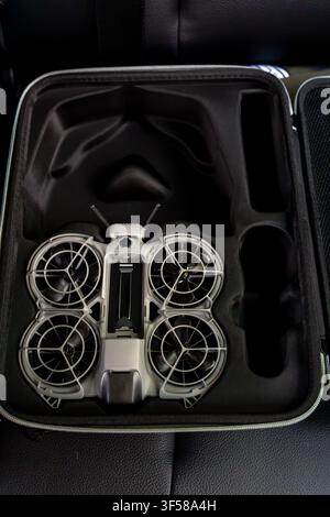 Small drone with controller and accessories packed in a protective carrying case vertical photo Stock Photo