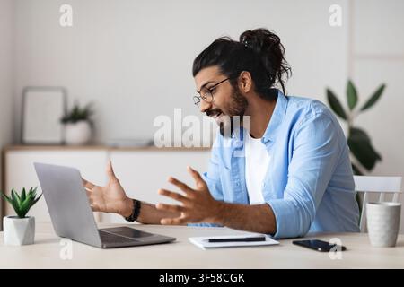 Young Arab Freelancer Guy Making Video Call With Laptop At Home Stock Photo
