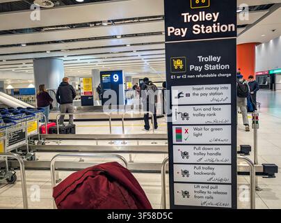 Manchester, UK, Jan.,13, 2026. View of luggage trolley payment station instruction board at the new Manchester Airport Terminal 2 baggage area Stock Photo