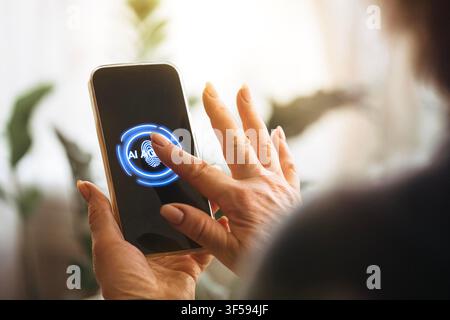 Close-up view of a hand interacting with a smartphone featuring a fingerprint scanner and AI interface, with indoor plants softly blurred in the background - Photomontage Stock Photo