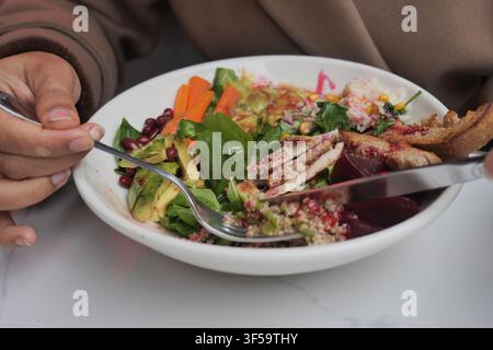 Healthy meal with salad and chicken on a white plate Stock Photo