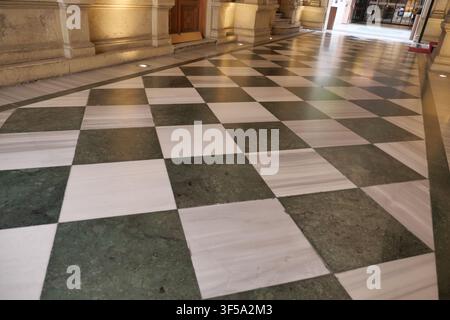 Checkered marble floor in a historic building hallway Stock Photo