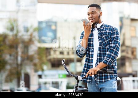Portrait of african man talking on phone using speaker Stock Photo